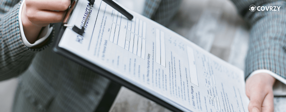 a hand showing a document attached in a clipboard