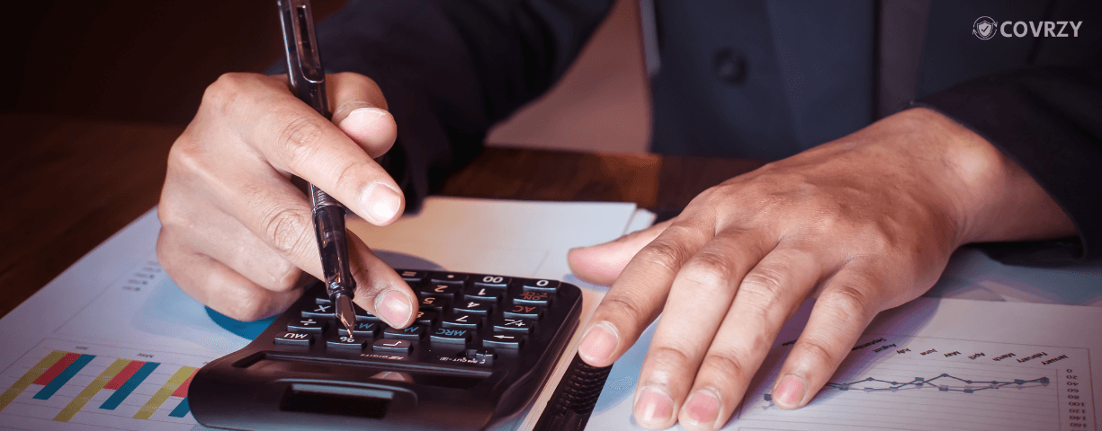 A person calculating the difference between operating profit and net profit