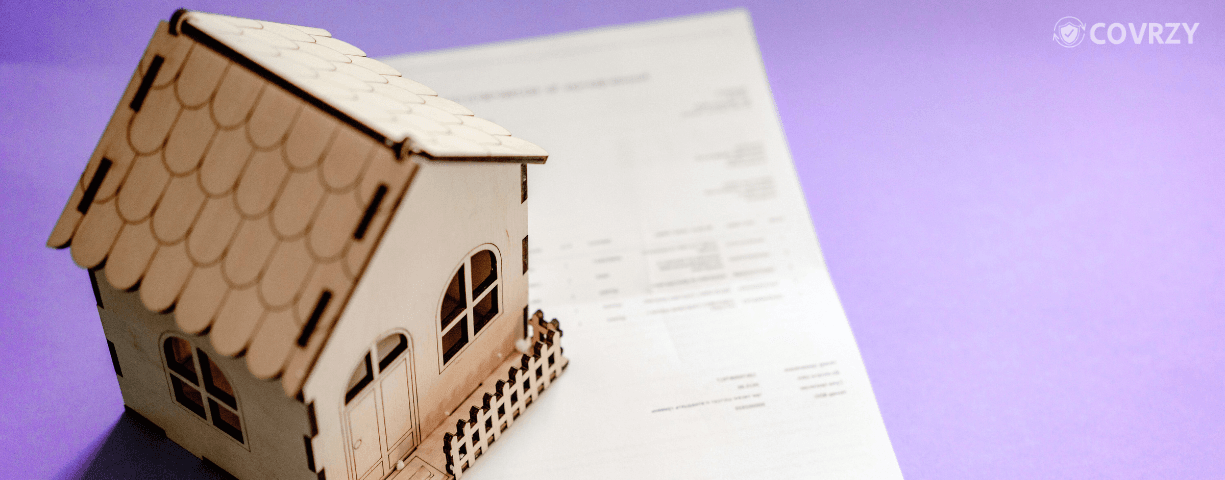 A miniature house with few keys and an application form for house rent allowance under it