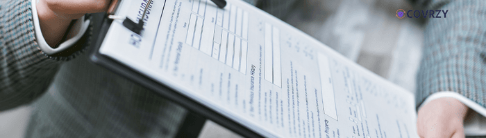 A person holding a clipboard which has a printed paper attached to it
