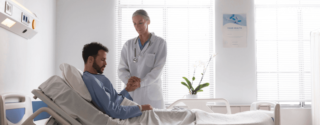 an old lady doctor standing near a patient and holding his hands